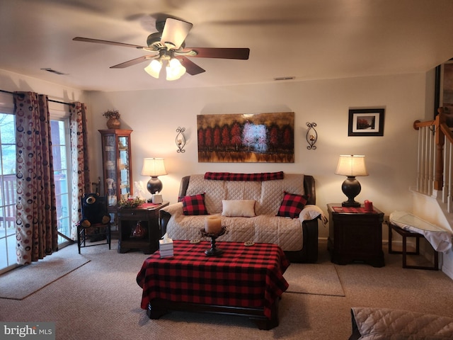 carpeted living room with ceiling fan