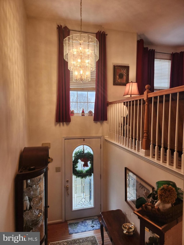 entryway featuring hardwood / wood-style floors and a notable chandelier