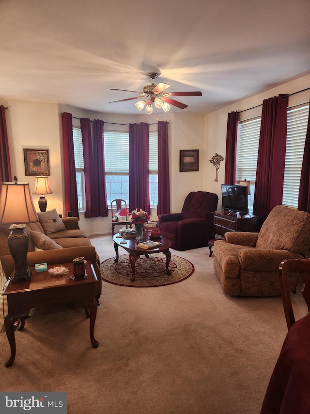 carpeted living room featuring ceiling fan