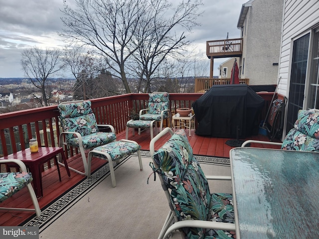 wooden deck featuring a grill