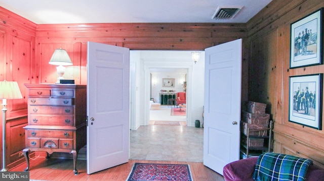 bedroom featuring wooden walls