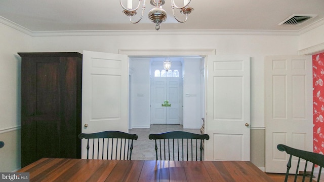 dining area with a notable chandelier and ornamental molding