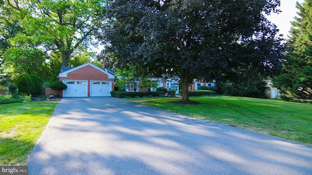 view of front facade with a garage and a front yard