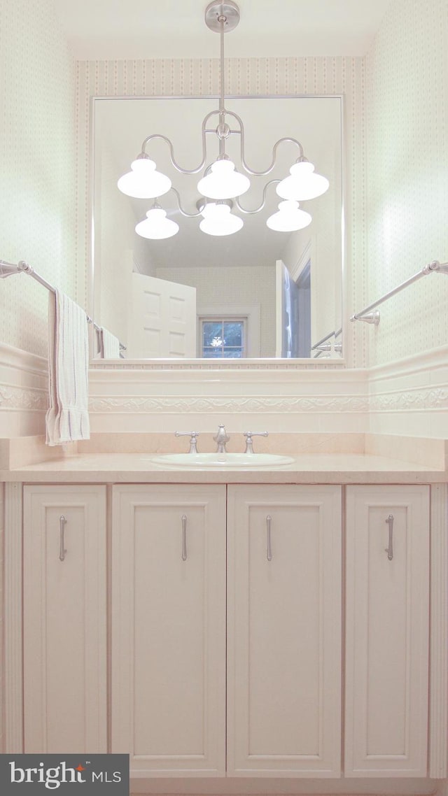 bathroom with a chandelier and vanity