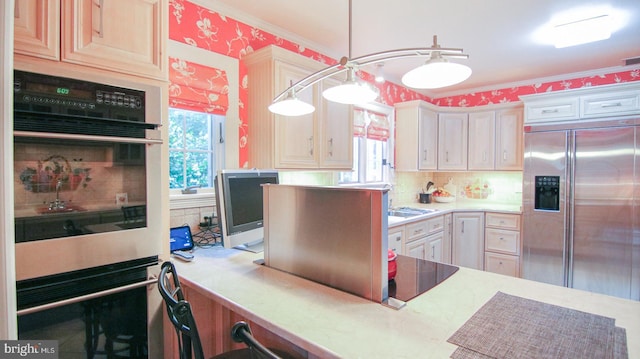 kitchen with pendant lighting, stainless steel appliances, a wealth of natural light, and ornamental molding