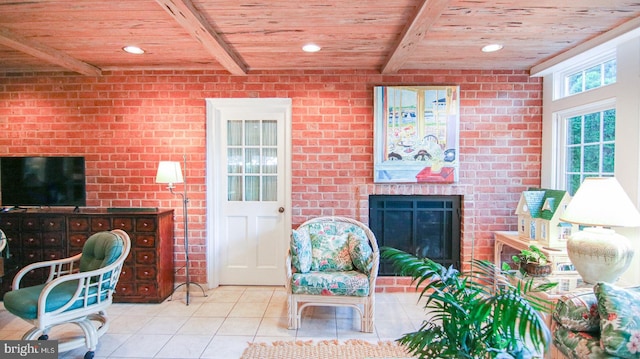 living room featuring light tile patterned floors, a brick fireplace, wooden ceiling, and beam ceiling