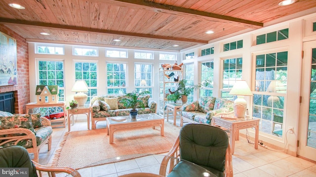 sunroom / solarium with beam ceiling, wood ceiling, and a brick fireplace