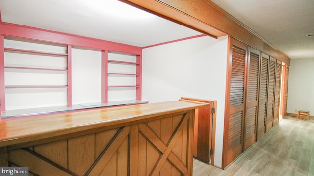 bar with light hardwood / wood-style floors