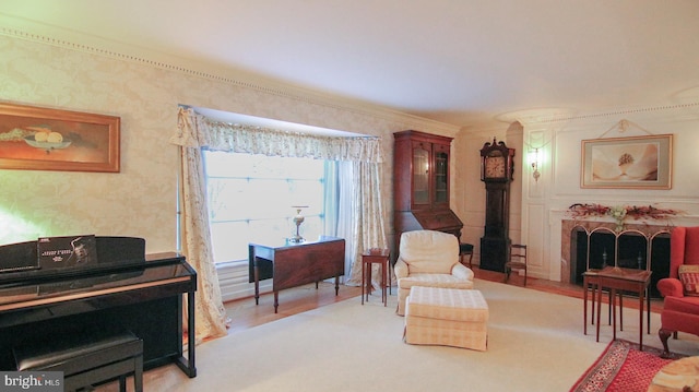 living area featuring crown molding and light hardwood / wood-style floors