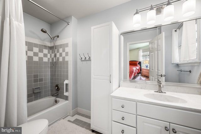 bathroom with tile patterned floors, shower / bath combo with shower curtain, toilet, baseboards, and vanity