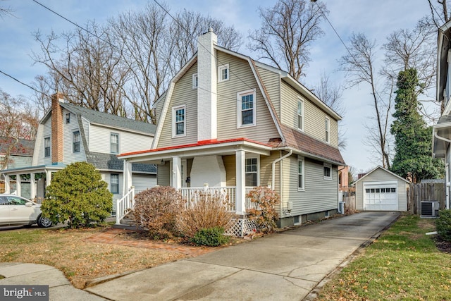 view of front facade featuring a porch, a garage, an outbuilding, and central AC