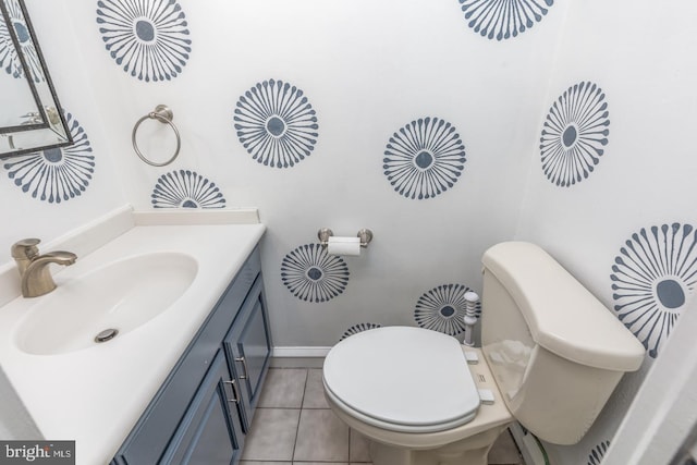 bathroom with tile patterned flooring, vanity, and toilet