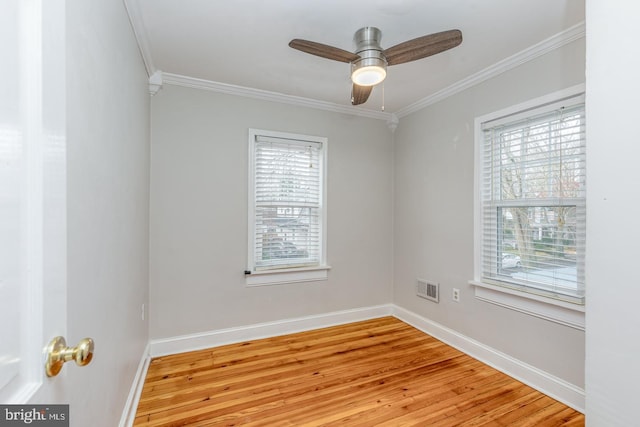 spare room with ceiling fan, ornamental molding, and light wood-type flooring