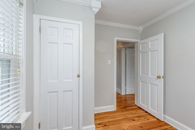 corridor featuring light hardwood / wood-style floors and ornamental molding