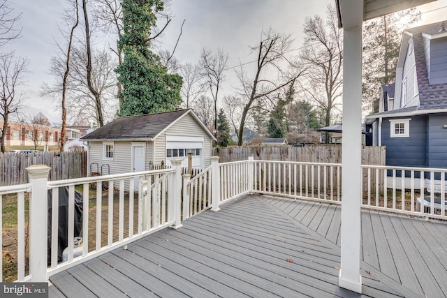 wooden terrace with an outbuilding and a garage