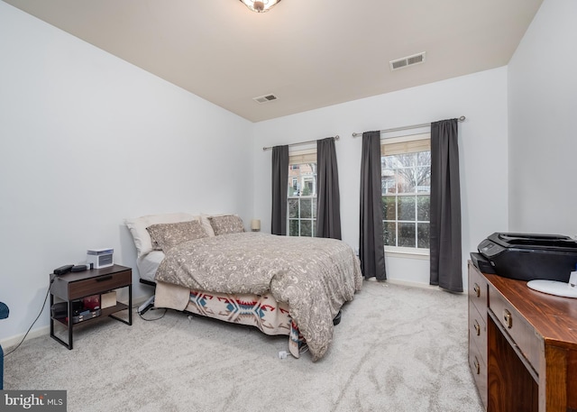 bedroom featuring light colored carpet