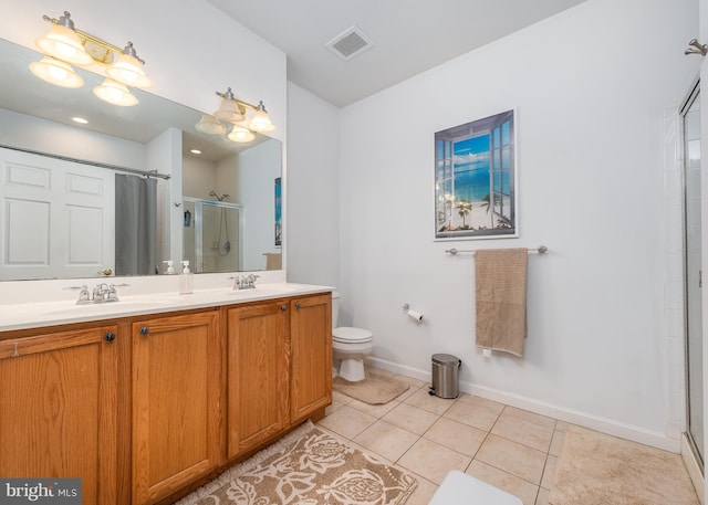 bathroom with toilet, tile patterned flooring, vanity, and walk in shower