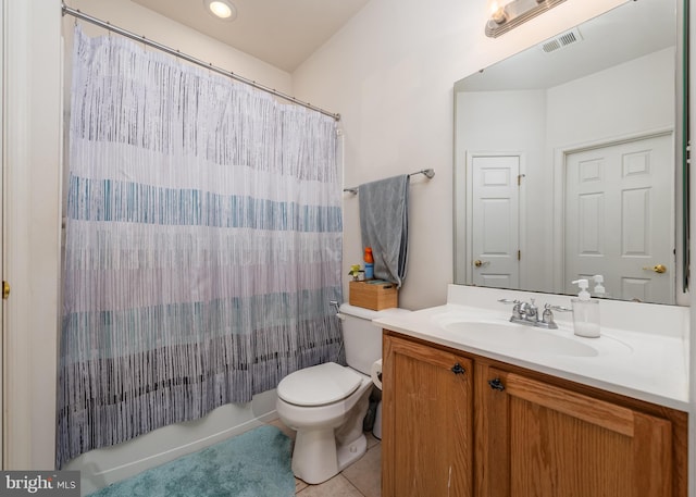 bathroom featuring tile patterned flooring, vanity, and toilet