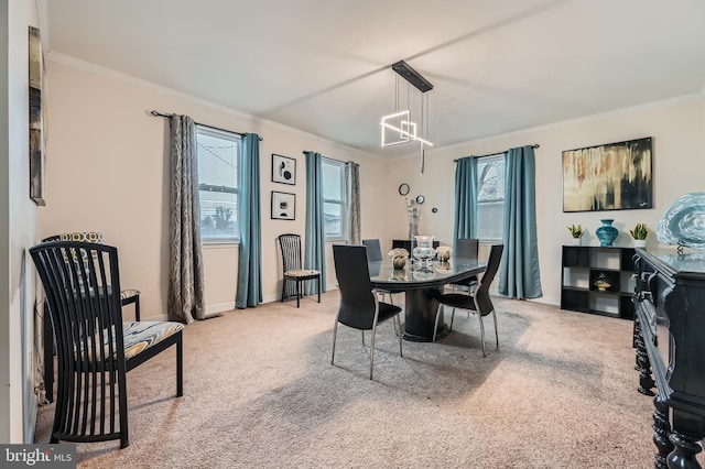 carpeted dining area featuring ornamental molding