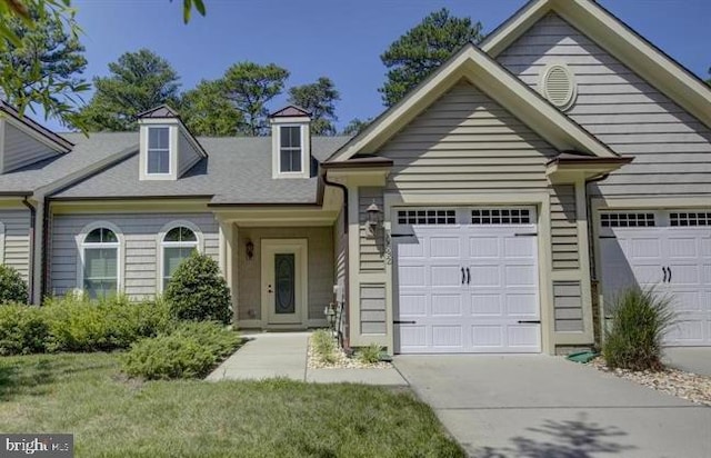 view of front of house featuring a garage and a front lawn