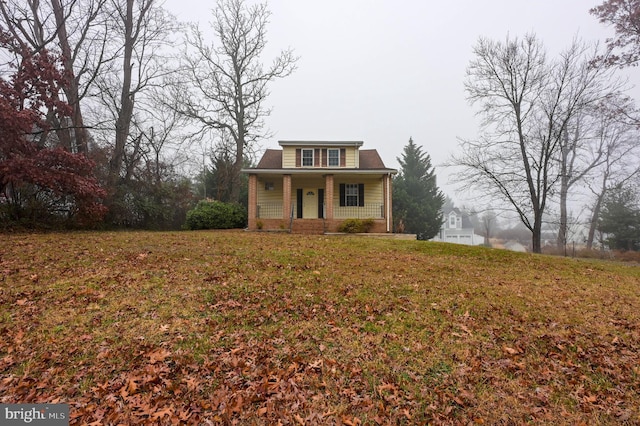 view of front facade with covered porch and a front lawn