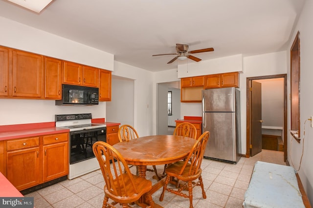 kitchen featuring white range with electric cooktop, stainless steel refrigerator, and ceiling fan