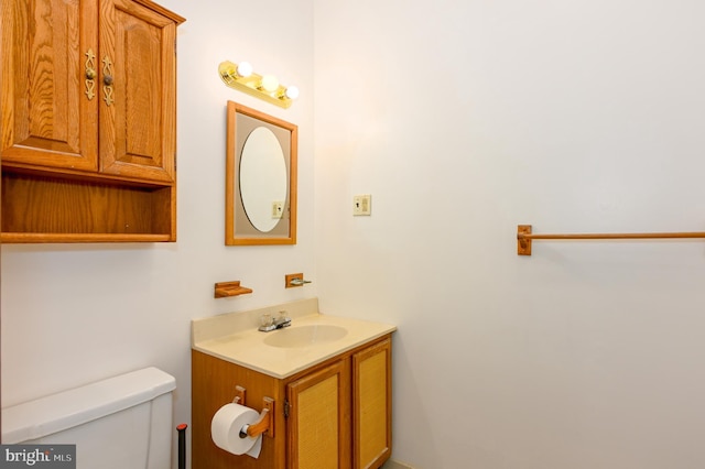 bathroom featuring vanity and toilet