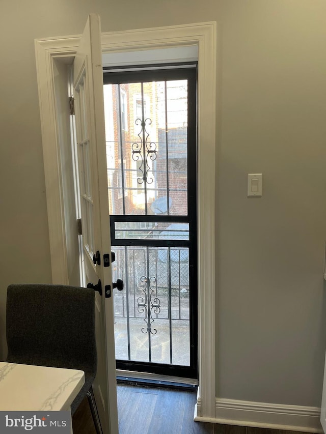 doorway to outside with wood-type flooring