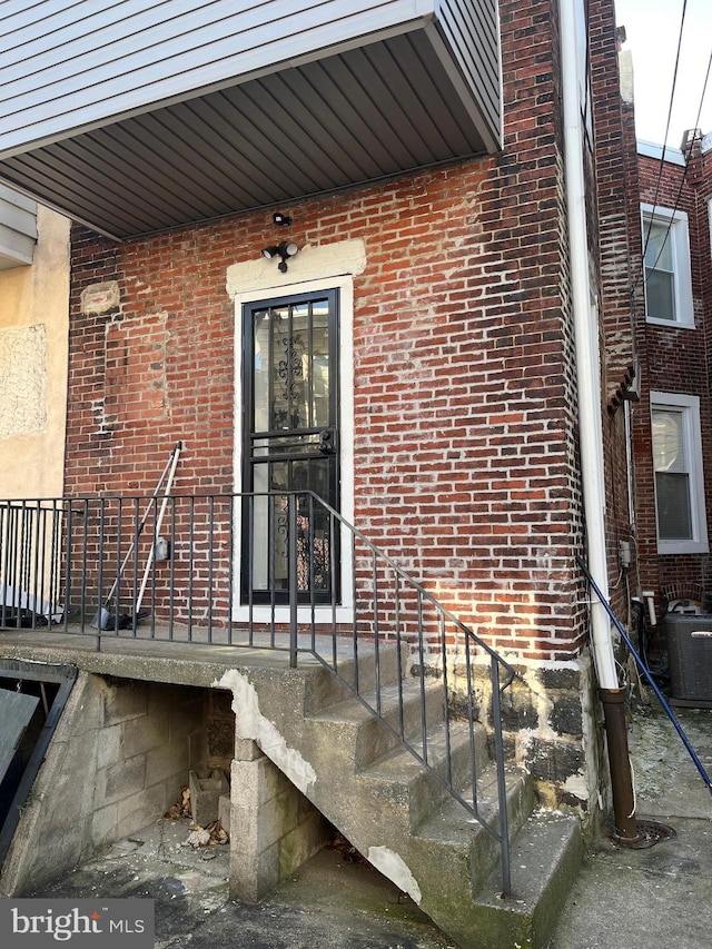 doorway to property with central AC unit