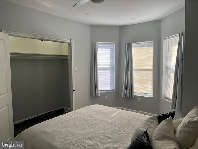 bedroom with ceiling fan and a closet