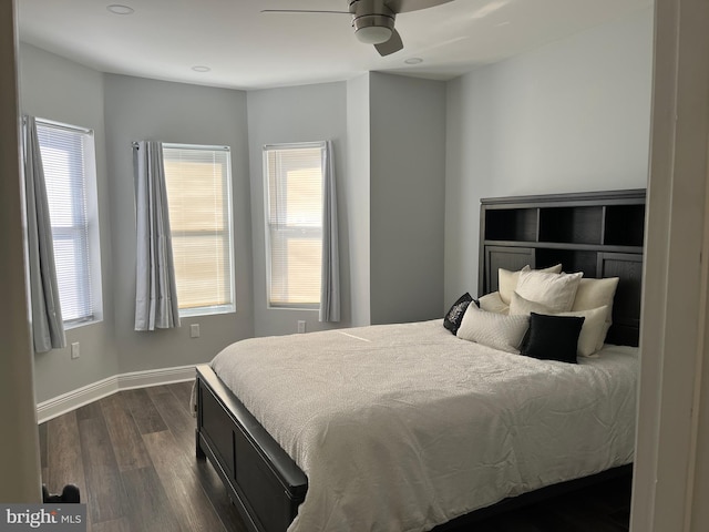 bedroom featuring multiple windows, ceiling fan, and dark wood-type flooring