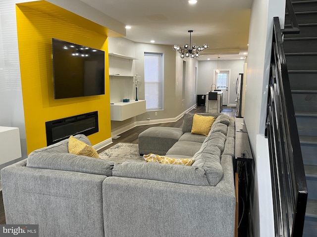 living room with a chandelier and dark hardwood / wood-style floors