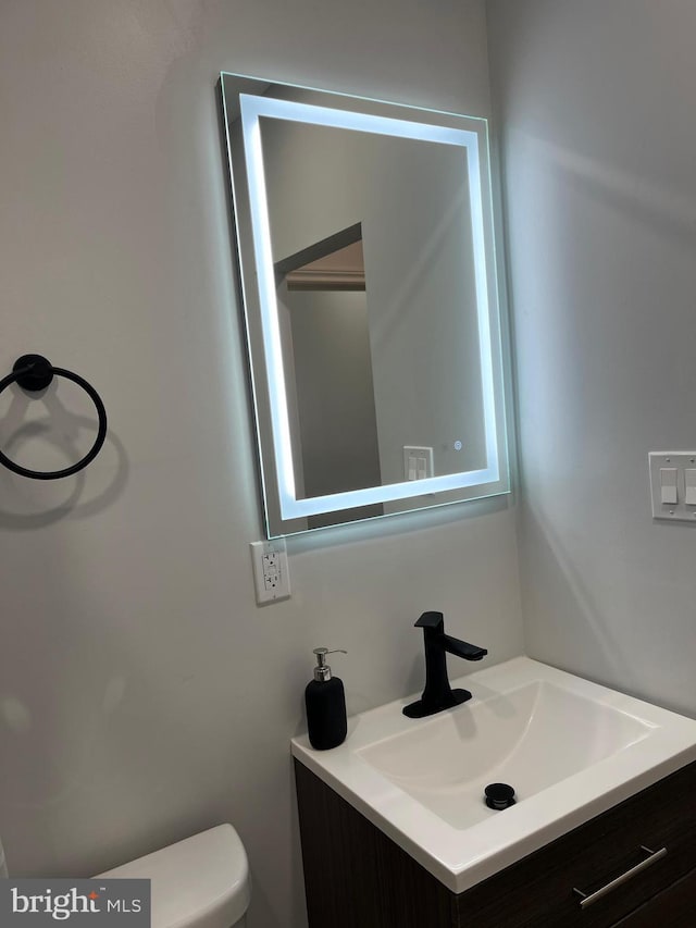 bathroom with vanity and toilet