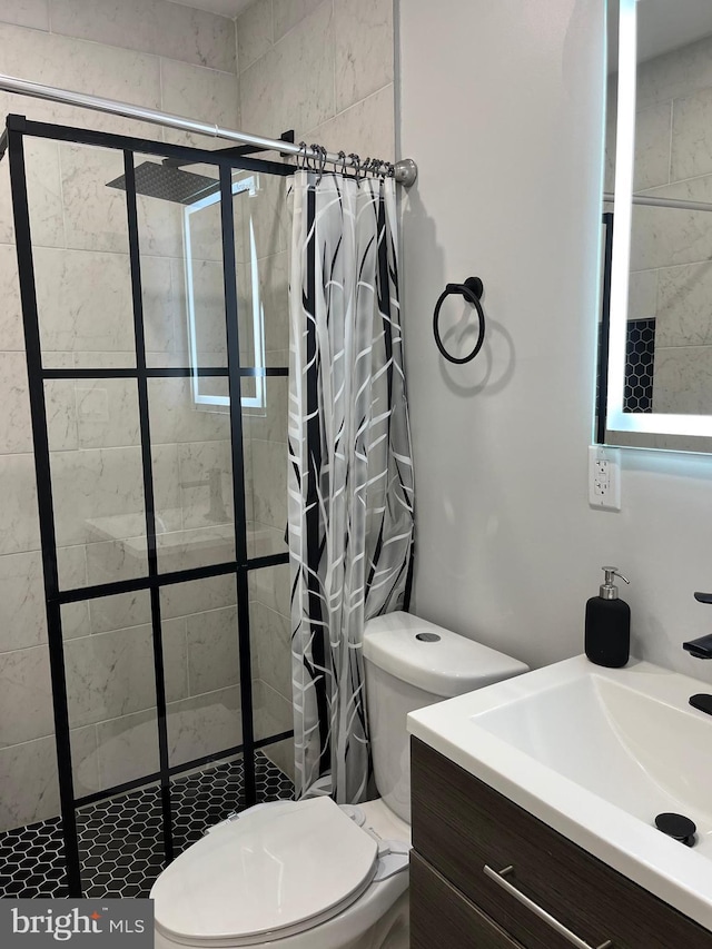 bathroom featuring vanity, curtained shower, and toilet