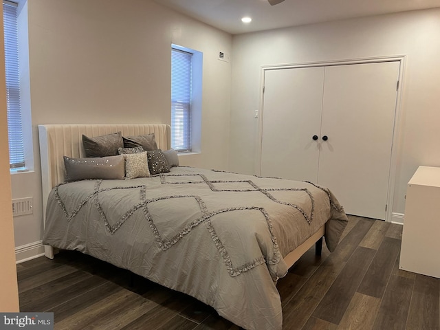 bedroom featuring dark hardwood / wood-style flooring and a closet