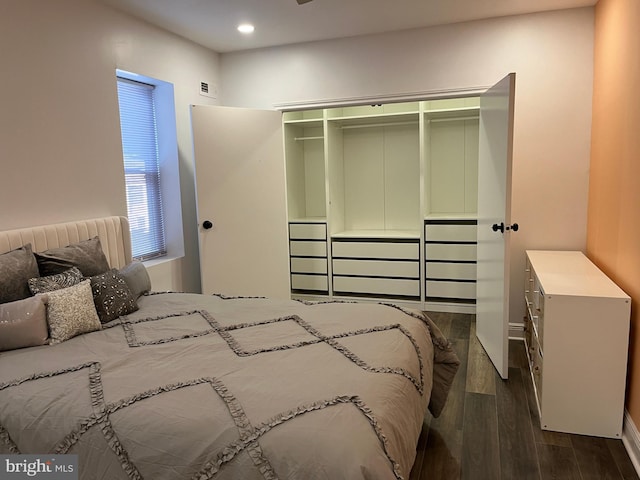 bedroom featuring dark hardwood / wood-style flooring and a closet