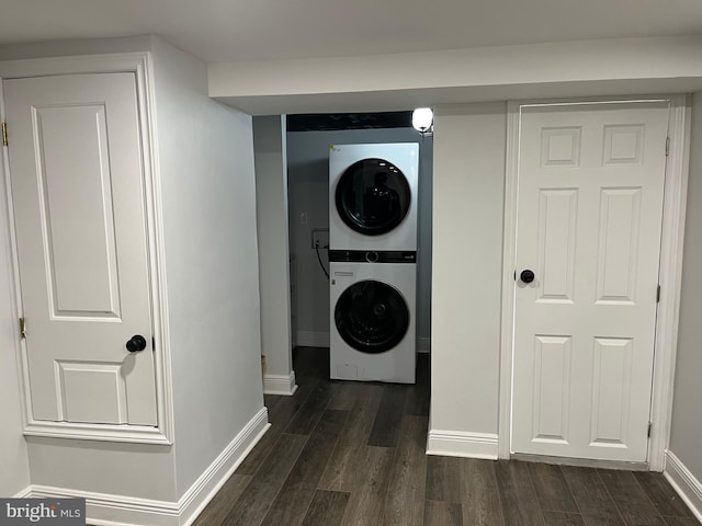 washroom with stacked washer and dryer and dark hardwood / wood-style floors