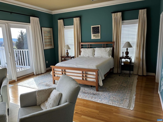 bedroom with light hardwood / wood-style floors, access to exterior, and ornamental molding