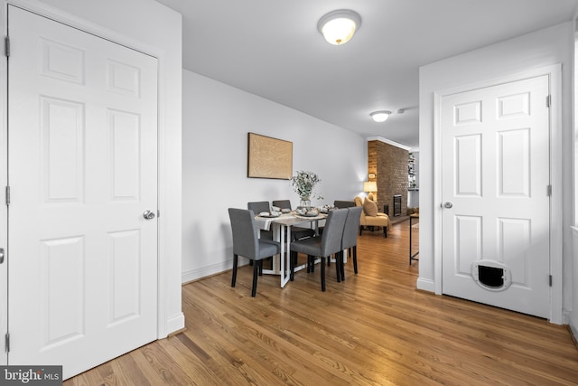 dining area featuring a fireplace and hardwood / wood-style floors