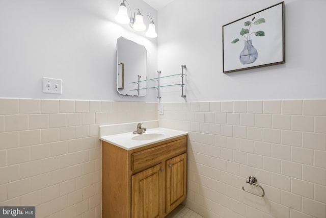 bathroom with vanity and tile walls