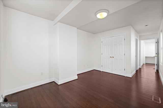 interior space with a closet and dark hardwood / wood-style floors