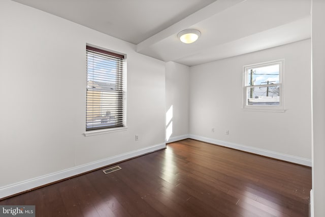 spare room with dark hardwood / wood-style floors