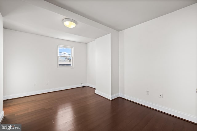 unfurnished room featuring dark wood-type flooring