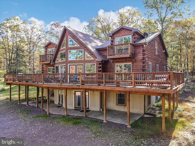 back of house featuring a patio area and a deck