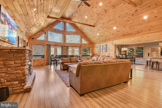 living room with beam ceiling, high vaulted ceiling, light hardwood / wood-style floors, wood ceiling, and ceiling fan with notable chandelier