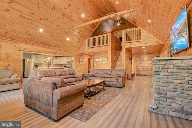 living room featuring beam ceiling, wooden ceiling, high vaulted ceiling, wood walls, and light wood-type flooring