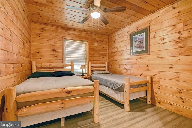 bedroom featuring light wood-type flooring, ceiling fan, wooden walls, and wood ceiling