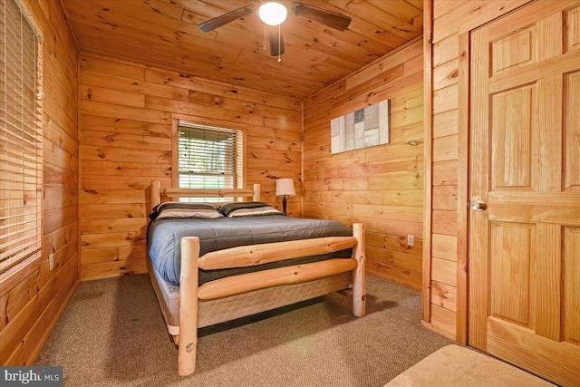 bedroom featuring carpet floors, ceiling fan, wooden ceiling, and wood walls