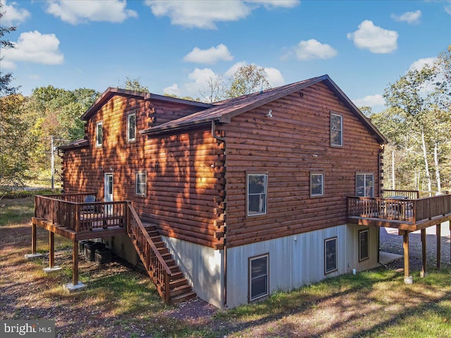 rear view of property with a wooden deck