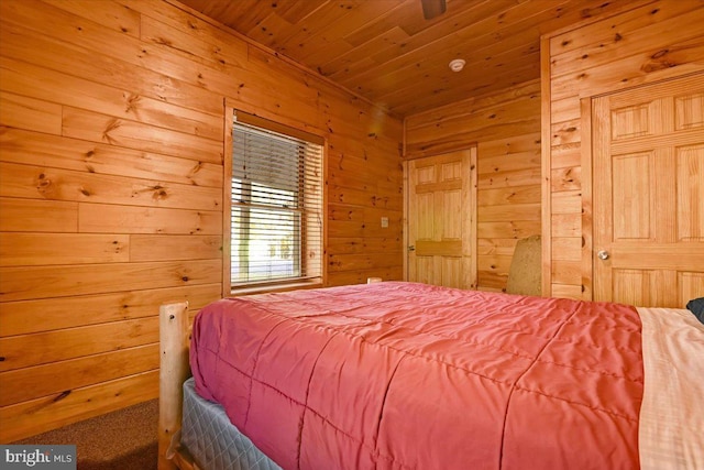 bedroom featuring wooden ceiling and wood walls